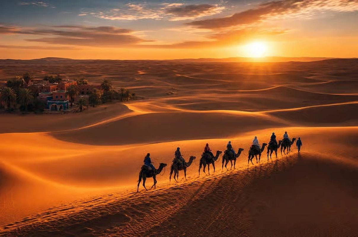Camel caravan crossing the Erg Chebbi dunes at sunset