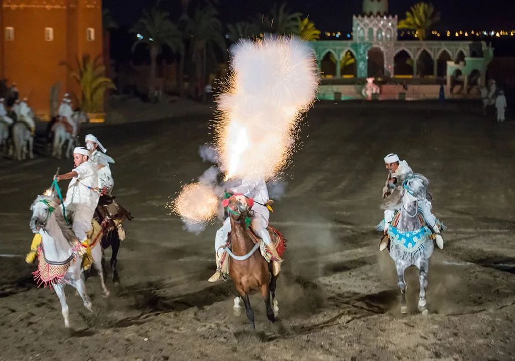 Horsemen firing gunpowder during the Chez Ali fantasia show