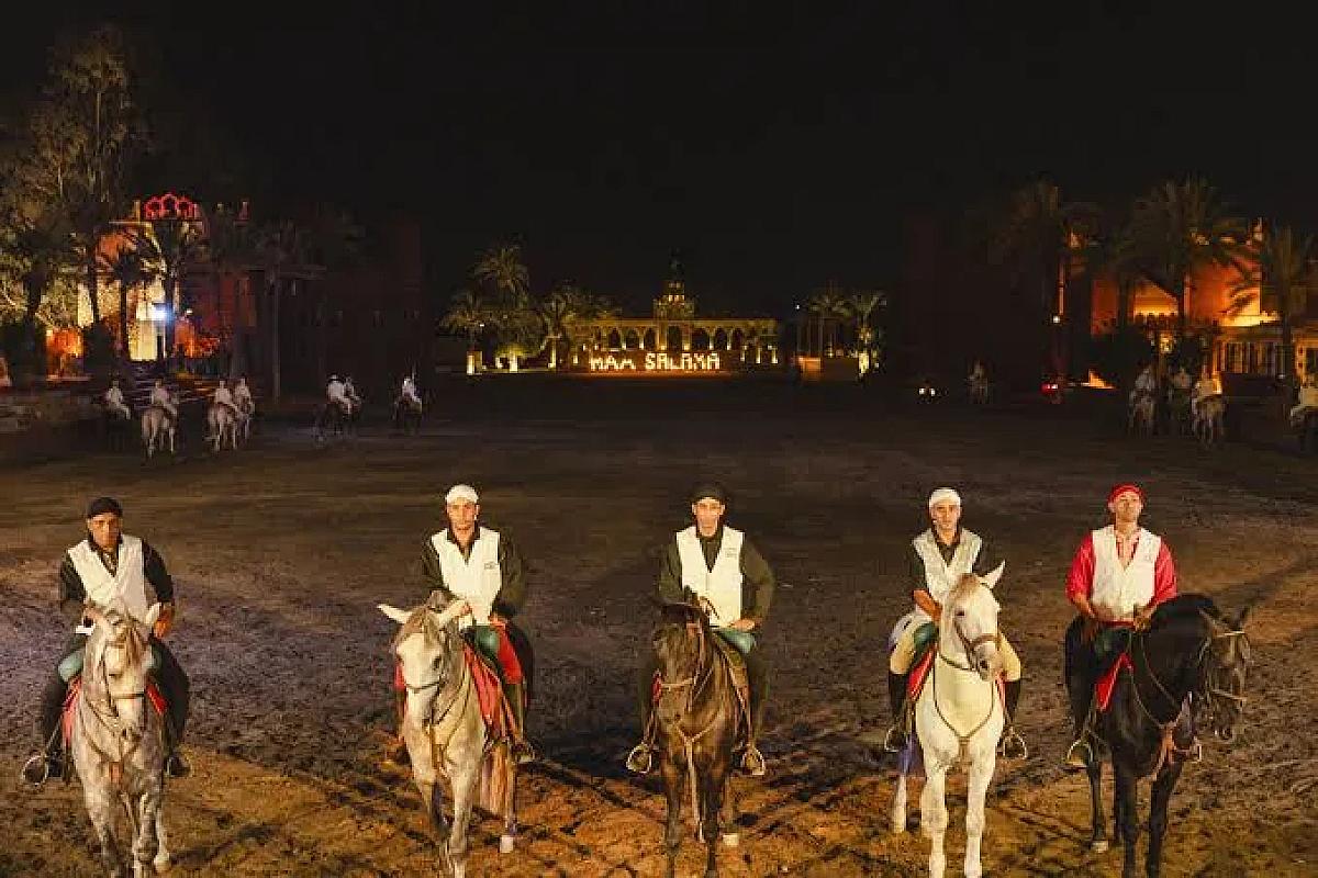 Costumed riders lined up on horseback at the Chez Ali evening show