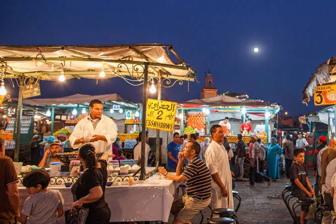 Food stalls glowing at dusk on Jemaa el-Fnaa square in Marrakech