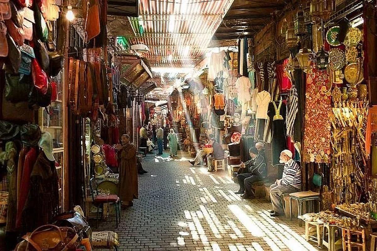 Sunbeams falling through a covered souk alley in the Marrakech medina