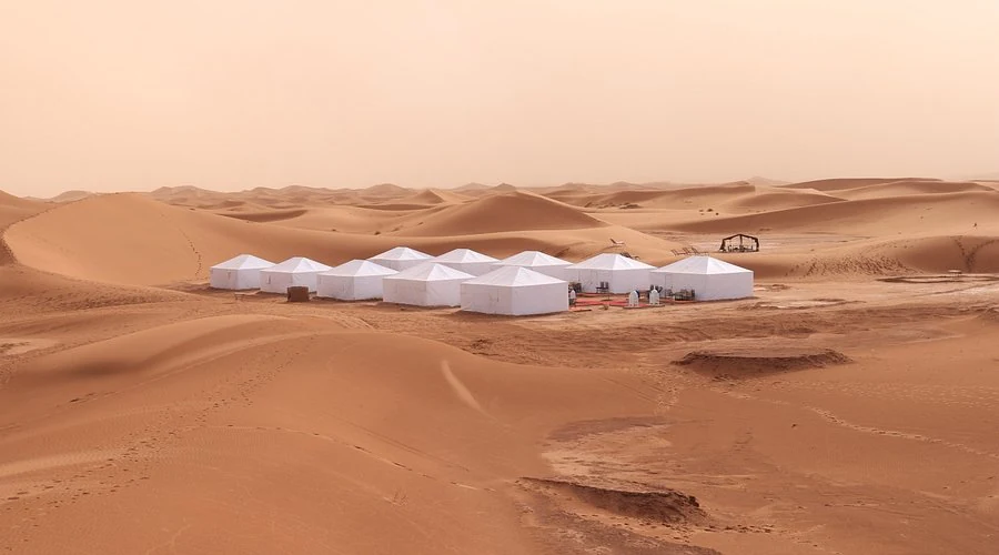 White tented camp set among the dunes of Erg Chigaga