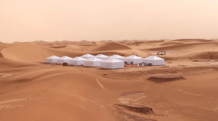 White tented camp set among the dunes of Erg Chigaga
