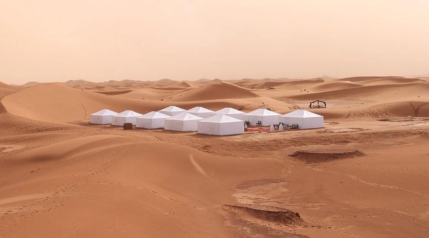 White tented camp set among the dunes of Erg Chigaga