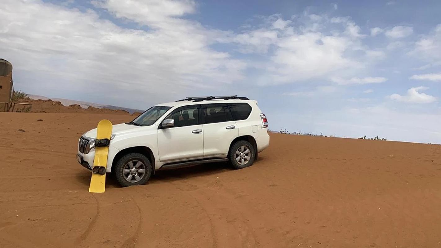 White 4x4 vehicle crossing the sands towards Erg Chigaga