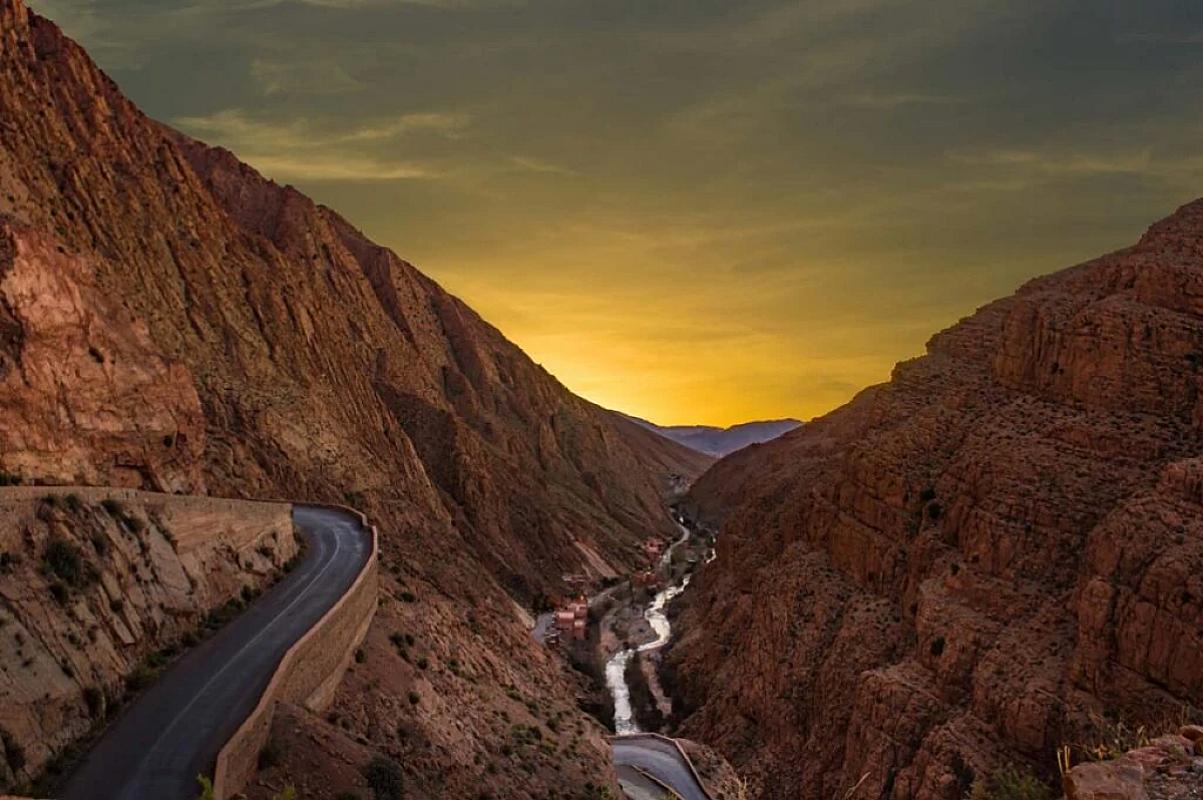 Road and river winding through the Dades gorges at dusk