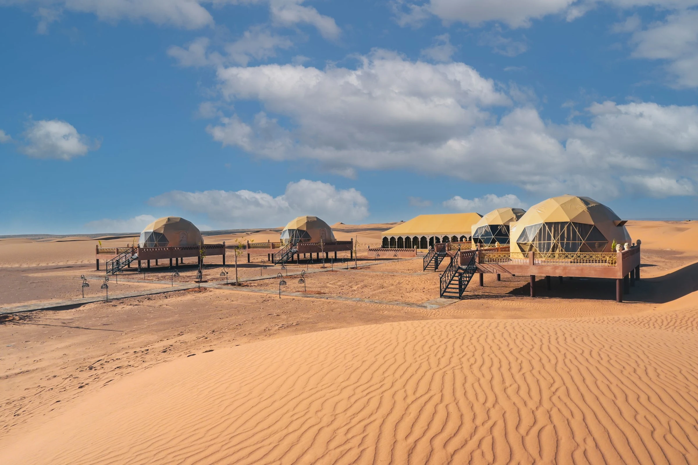 Dome tents of a desert camp set on the Merzouga dunes