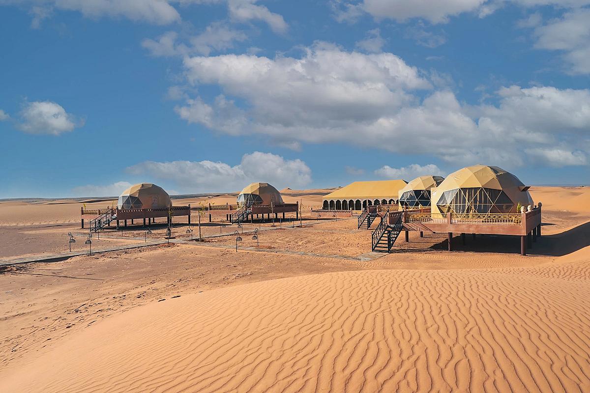 Dome tents of a desert camp set on the Merzouga dunes