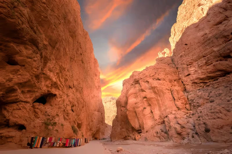 Carpet stalls beneath the towering walls of the Todra gorge