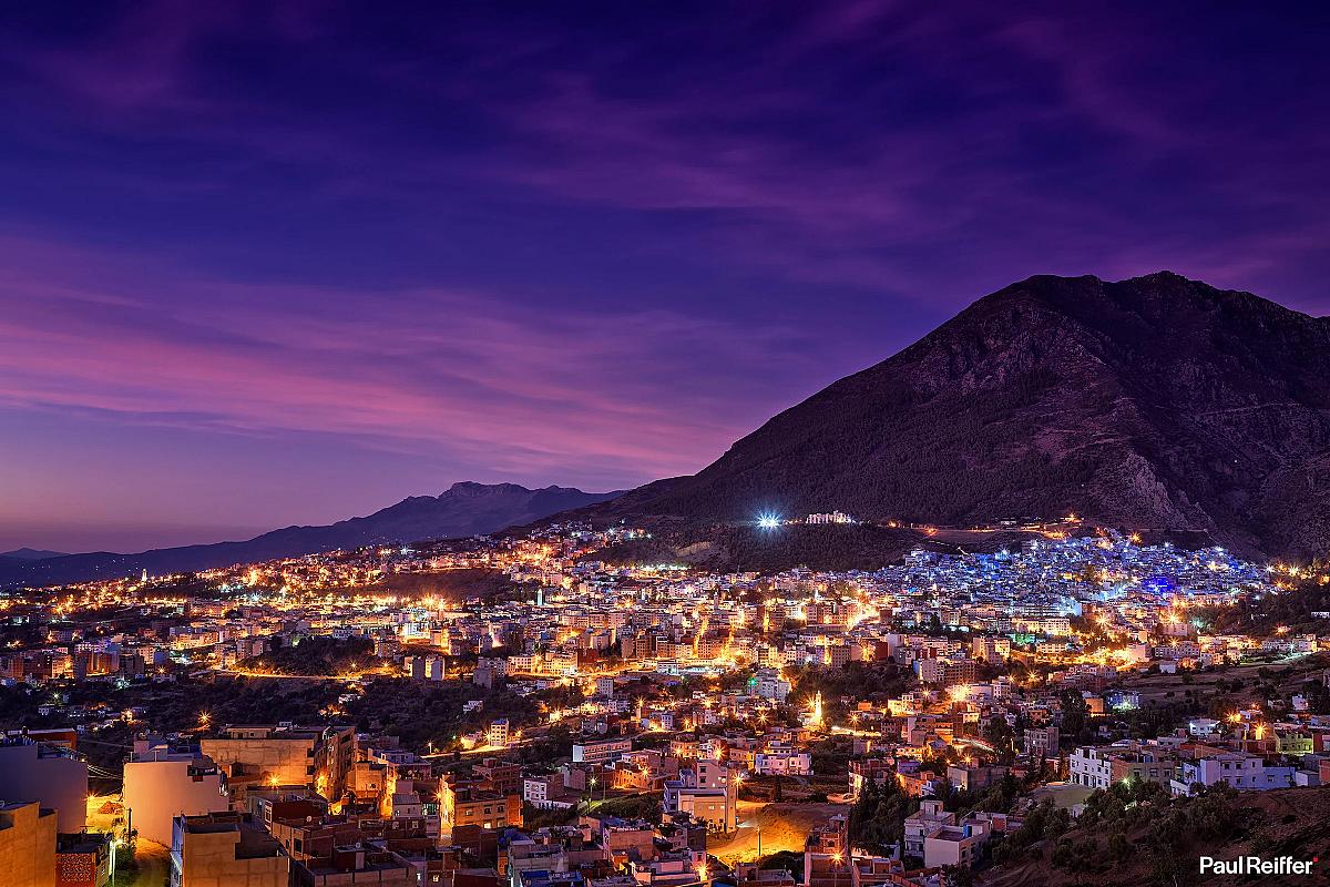 Chefchaouen glowing at night beneath the Rif mountains