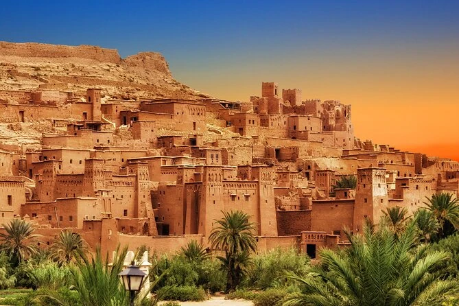 Ait Benhaddou ksar above palm groves in warm sunset light