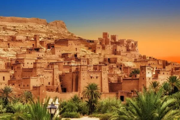 Ait Benhaddou ksar above palm groves in warm sunset light