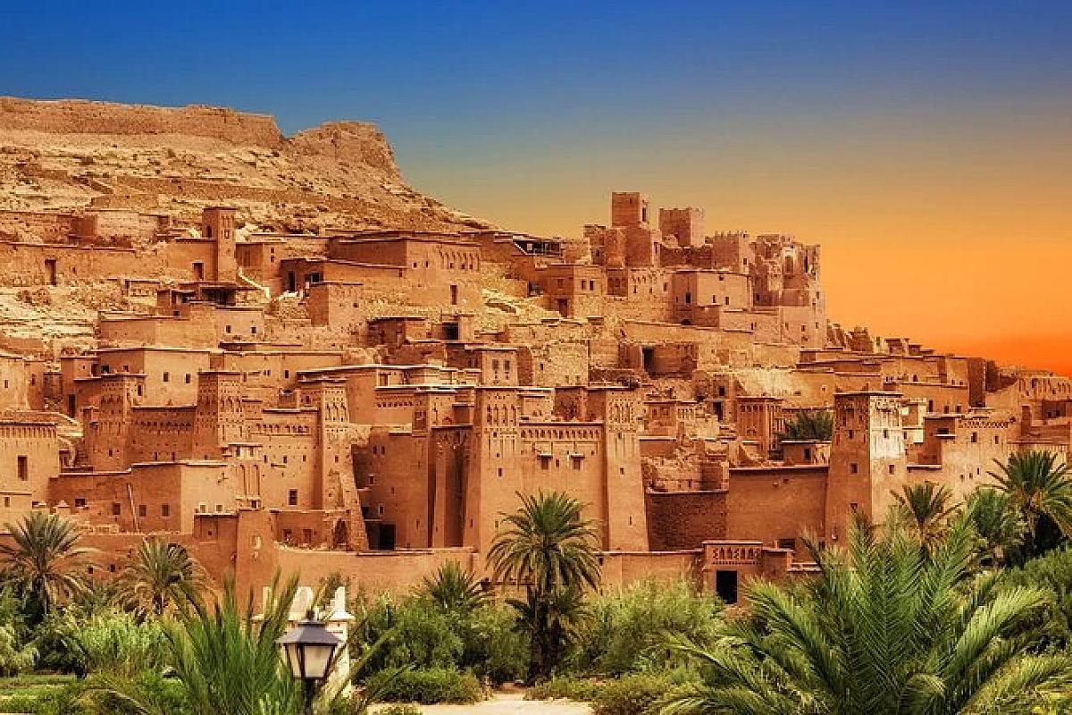 Ait Benhaddou ksar above palm groves in warm sunset light