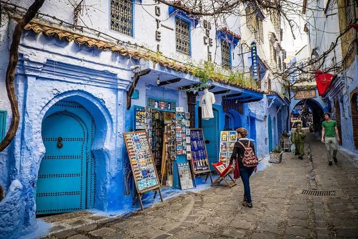 Souvenir shops lining a blue street in the Chefchaouen medina