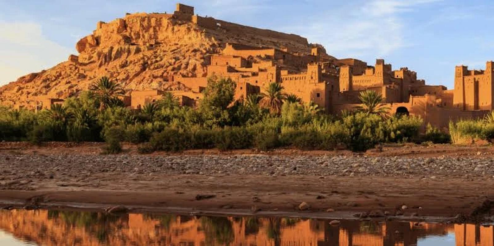 Ait Benhaddou ksar mirrored in the river at golden hour