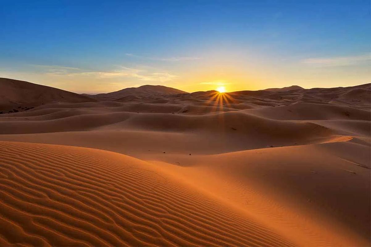 Sun rising over the rippled dunes of Erg Chebbi