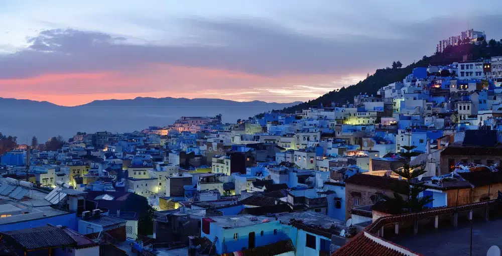Blue-washed houses of Chefchaouen glowing at dusk