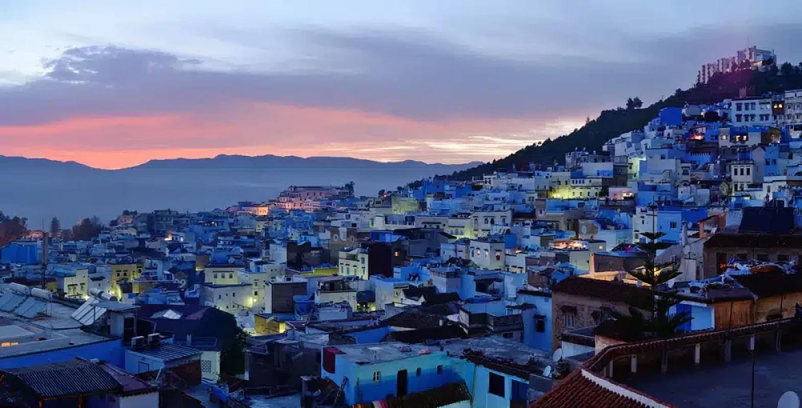 Blue-washed houses of Chefchaouen glowing at dusk