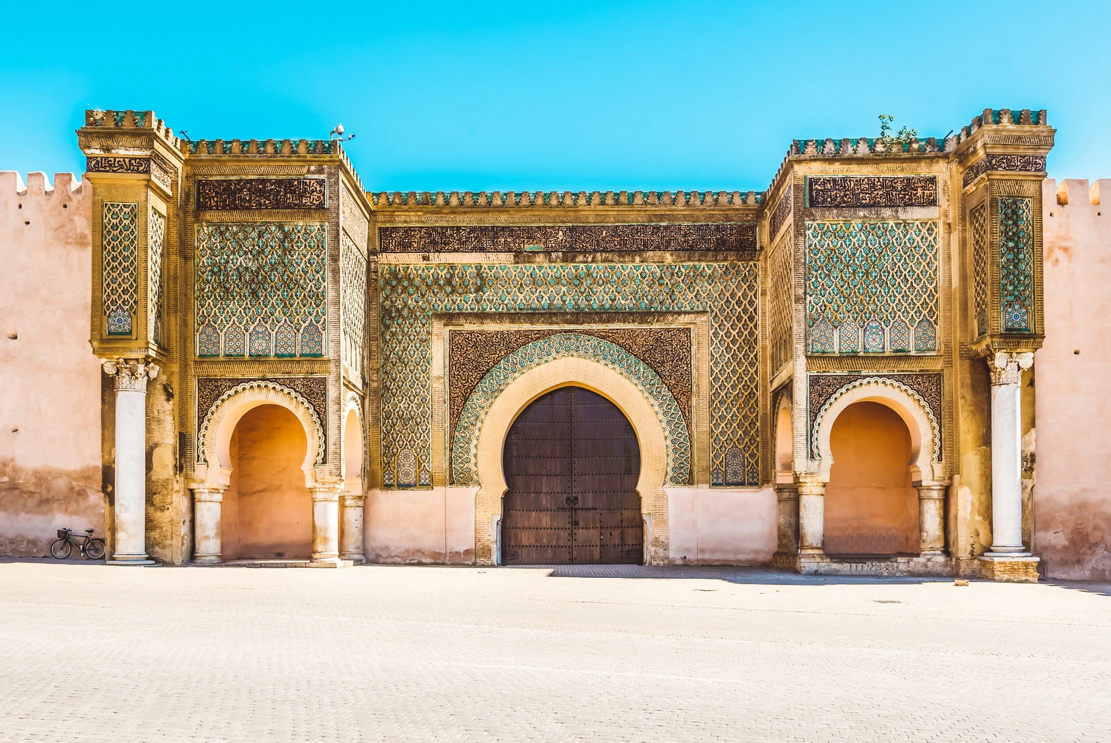 Ornate tiled facade of the Bab Mansour gate in Meknes