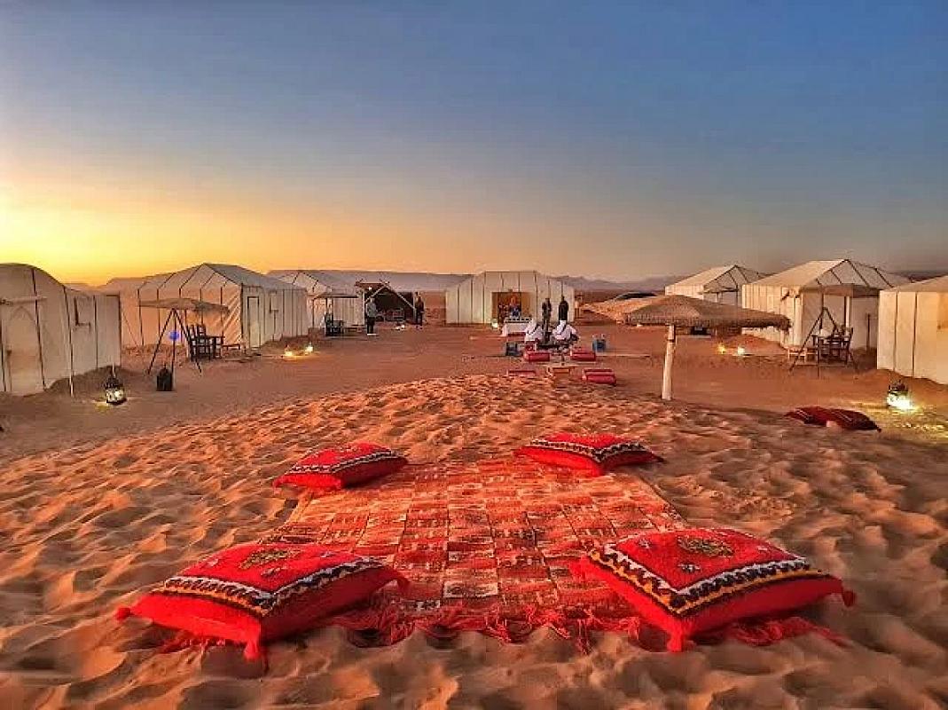 Berber rugs and tents of a Sahara desert camp at dusk