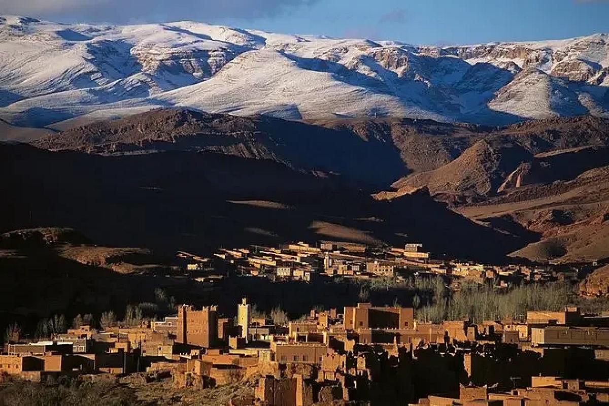 Atlas kasbah below snow-capped peaks